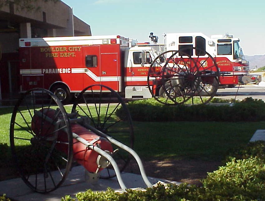 A fire truck and a paramedic response vehicle parked next to a fire station